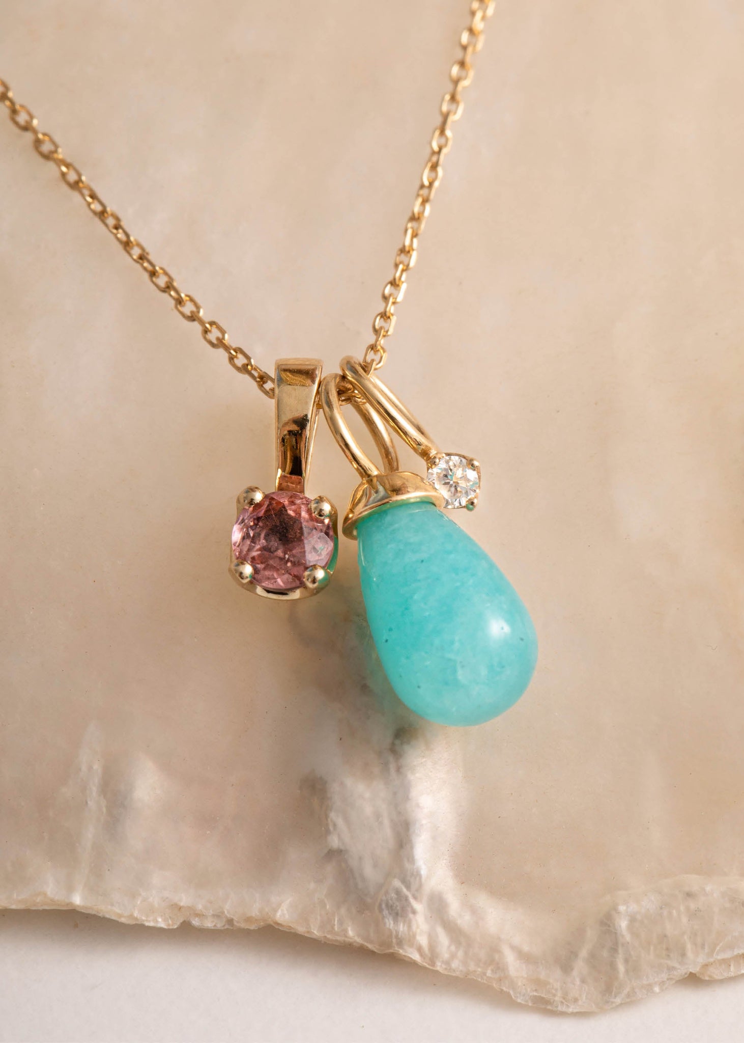 Woman with a flower shaped blue earring. The earring is made of a Prasiolite gemstone and Amazonite gemstones