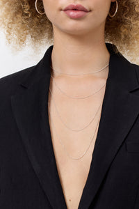 Woman wearing silver chains from Carré.