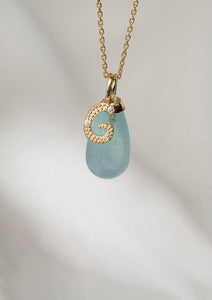 Two solid gold pendants from Carré. The blue is an Aquamarine pendant which is March's birthstone, and the second is a letter pendant with diamonds with the letter G 