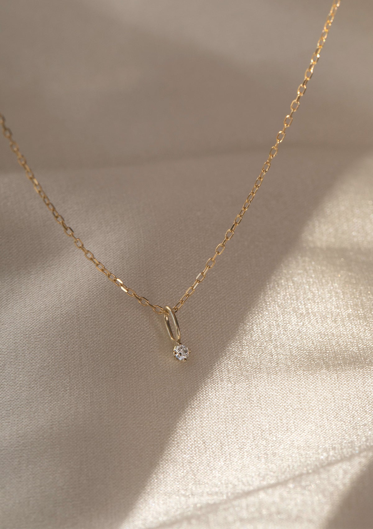 a 10-karat chain from Carré with a diamond pendant from Carré