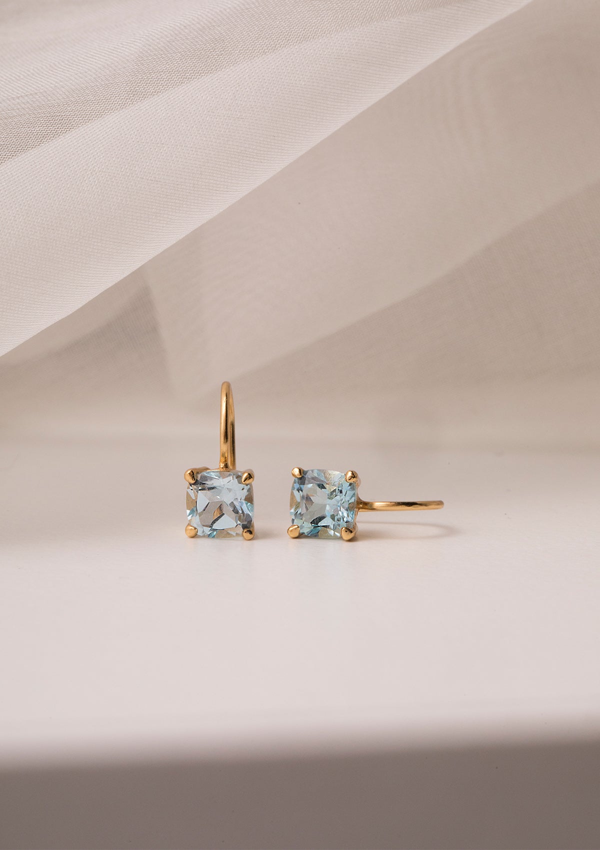 Gold plated earrings from Carré, set with a Blue Topaz gemstone. The blue topaz is also November's birthstone