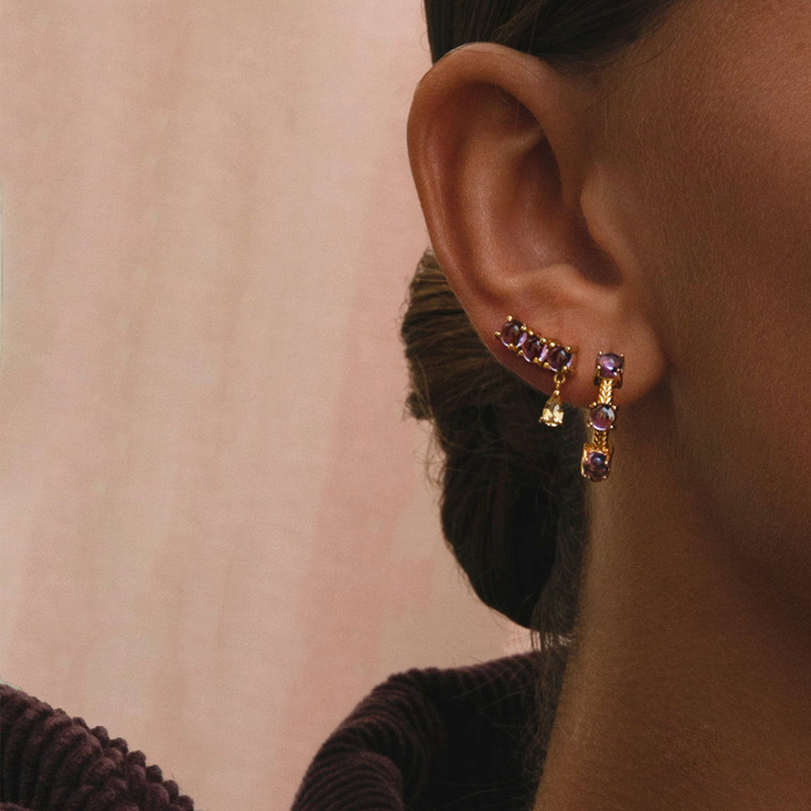 young woman wearing gold plated amethyst earrings and hoops from carré