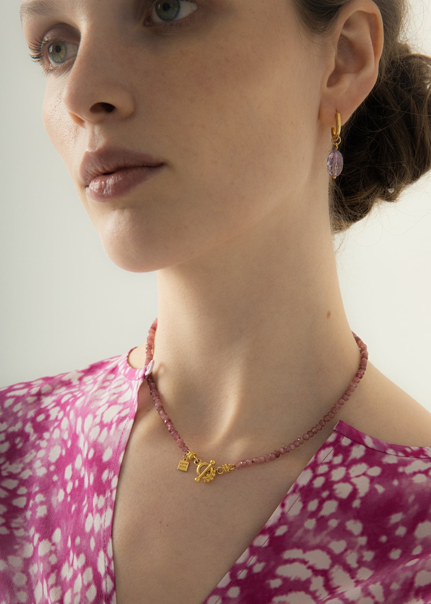 Woman wearing large amethyst earrings in gold plated sterling silver for everyday use and office jewellery