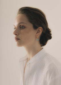 Woman wearing elegant large blue Aquamarine hoops for something blue for wedding days and confirmations