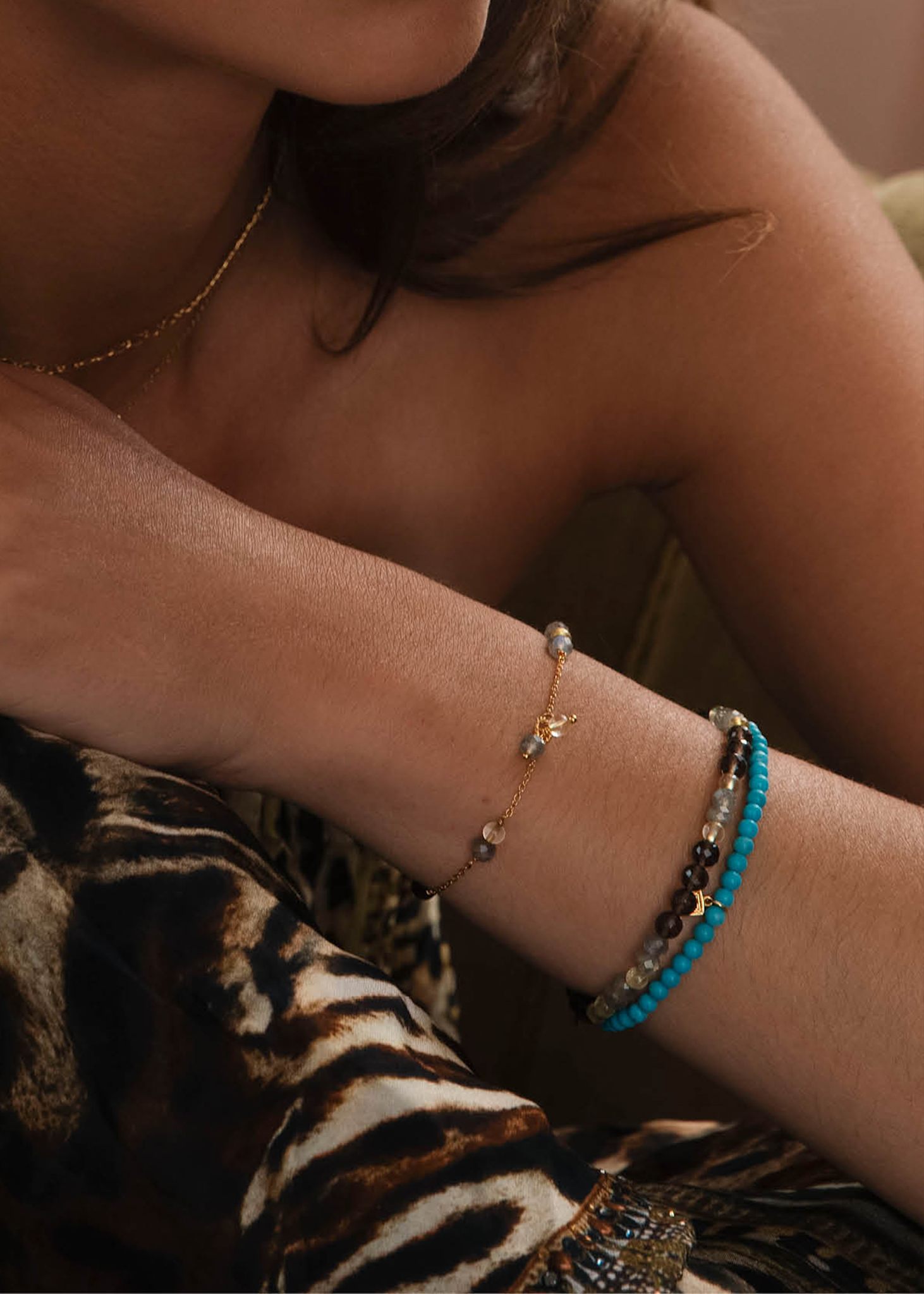 Woman with beaded gemstone bracelets in brown and blue colours