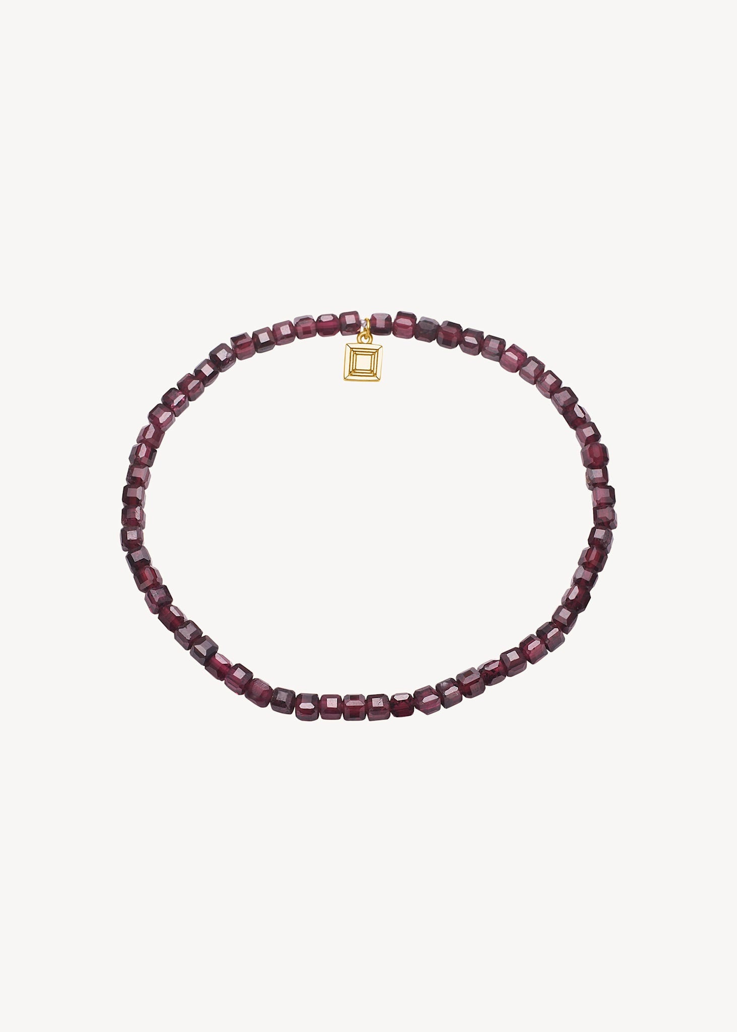 Slip on gemstone friendship bracelet from Carré Jewellery set with January's birthstone Red Garnet in a cubic cut