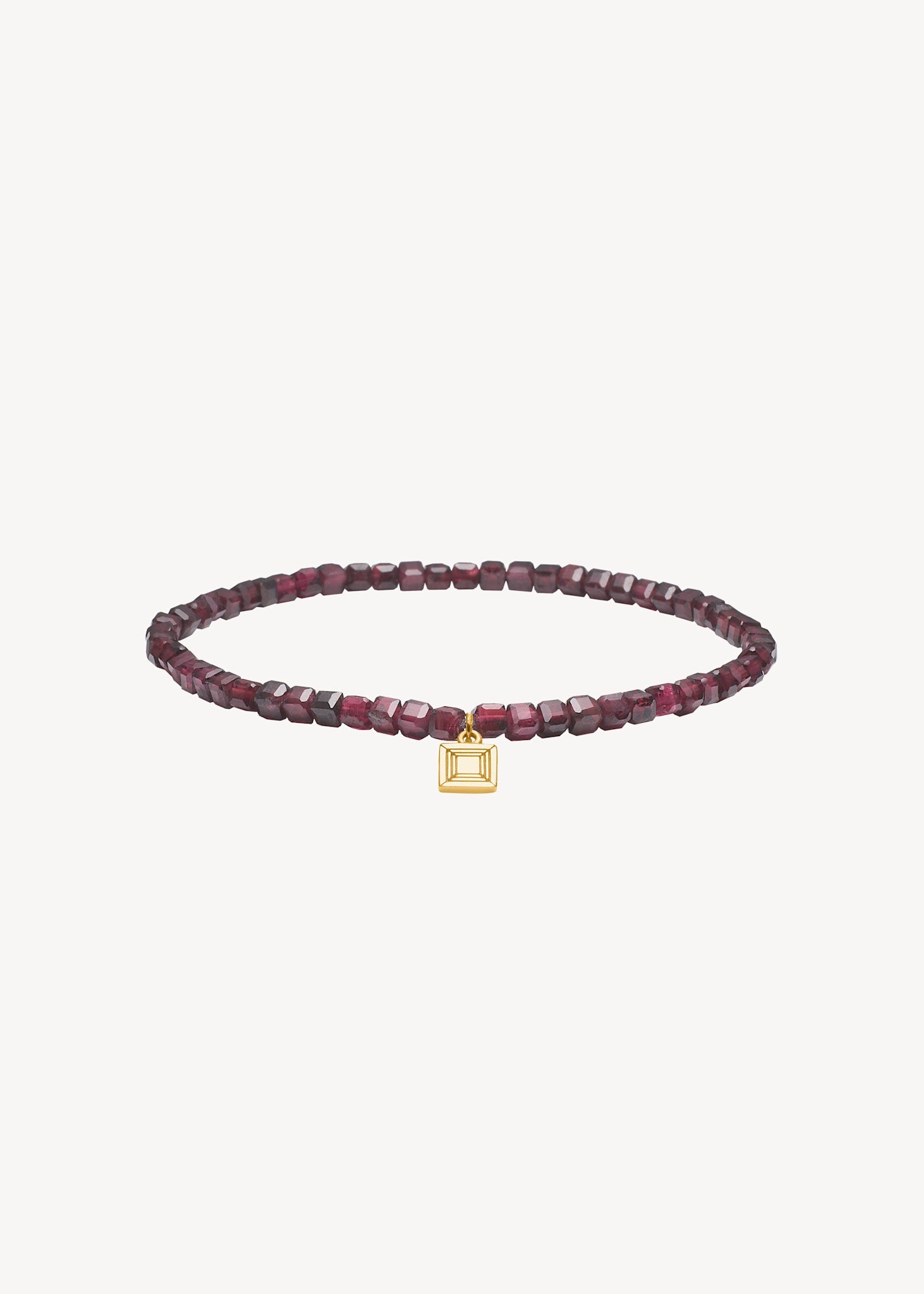 Slip on gemstone friendship bracelet from Carré Jewellery set with January's birthstone Red Garnet in a cubic cut