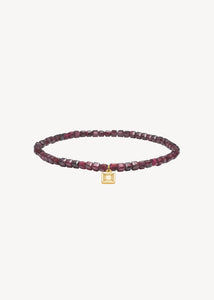 Slip on gemstone friendship bracelet from Carré Jewellery set with January's birthstone Red Garnet in a cubic cut