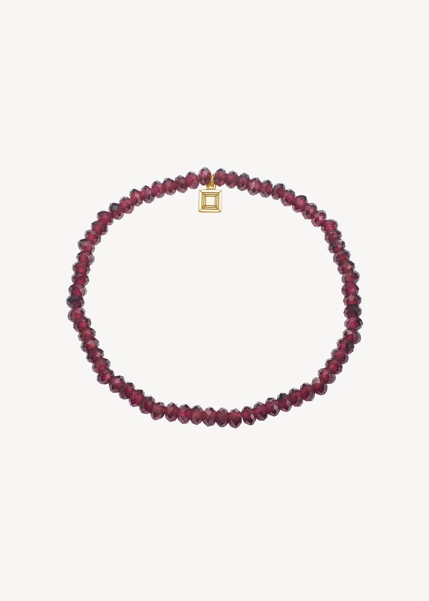 Slip on gemstone friendship bracelet from Carré Jewellery set with January's birthstone Red Garnet in a facet cut