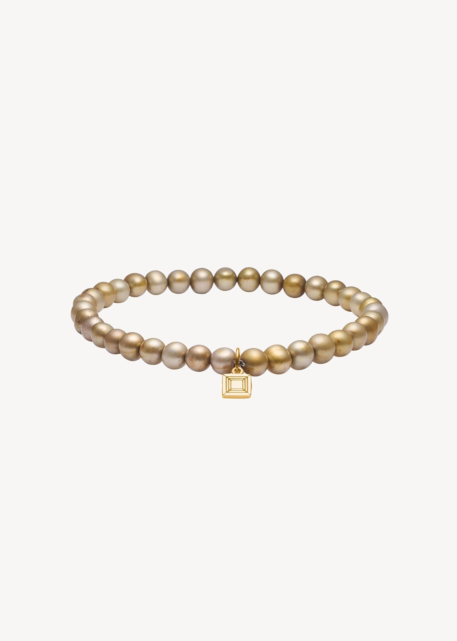 Slip on gemstone friendship bracelet from Carré Jewellery set with June's birthstone, golden freshwater pearl gemstones