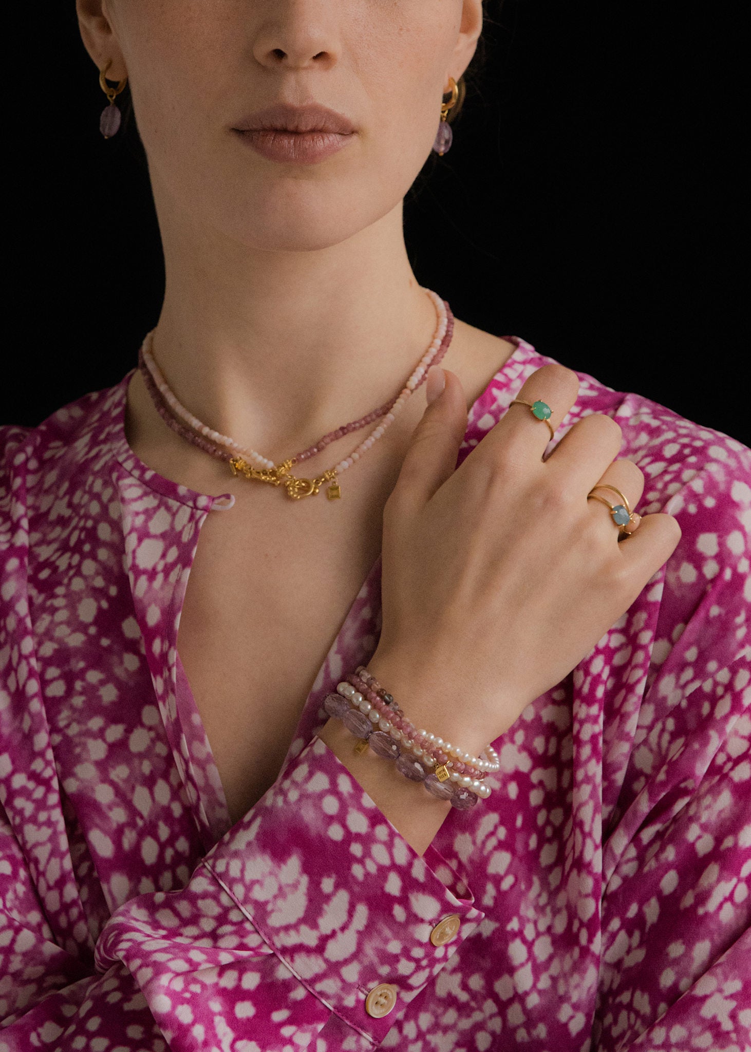 Woman wearing pink beaded jewellery handmade in Copenhagen with pink tourmalines, pink spinel, freshwater pearls and sand moonstone gemstones