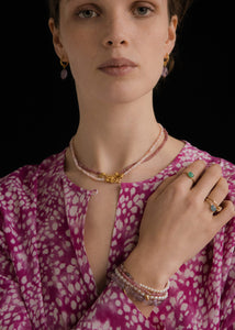 Woman with pink handmade beaded necklaces and bracelets in a boho style from Carré Copenhagen