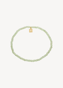 Unikt elastik armbånd i guldbelagt sterling sølv med augusts fødselssten, grøn peridot ædelsten. Perfekt gave til hende og ham med symbolik