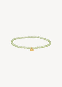 Unikt elastik armbånd i guldbelagt sterling sølv med augusts fødselssten, grøn peridot ædelsten. Perfekt gave til hende og ham med symbolik