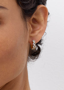 Close up of a gem hoop earring with blue topaz gemstones