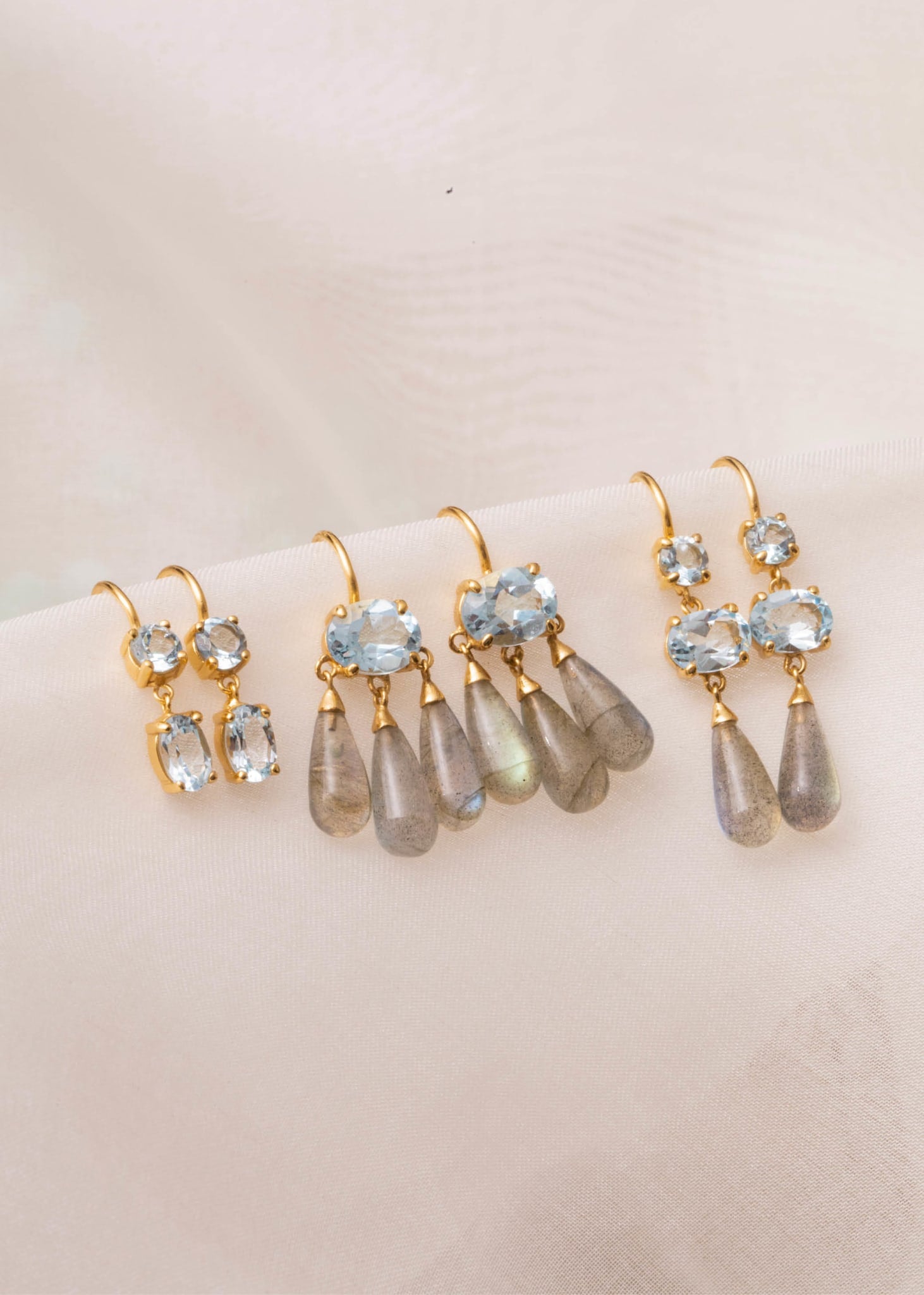 Gold plated large earrings from carré jewellery with blue topaz gemstones and cabochon cut labradorite gemstones