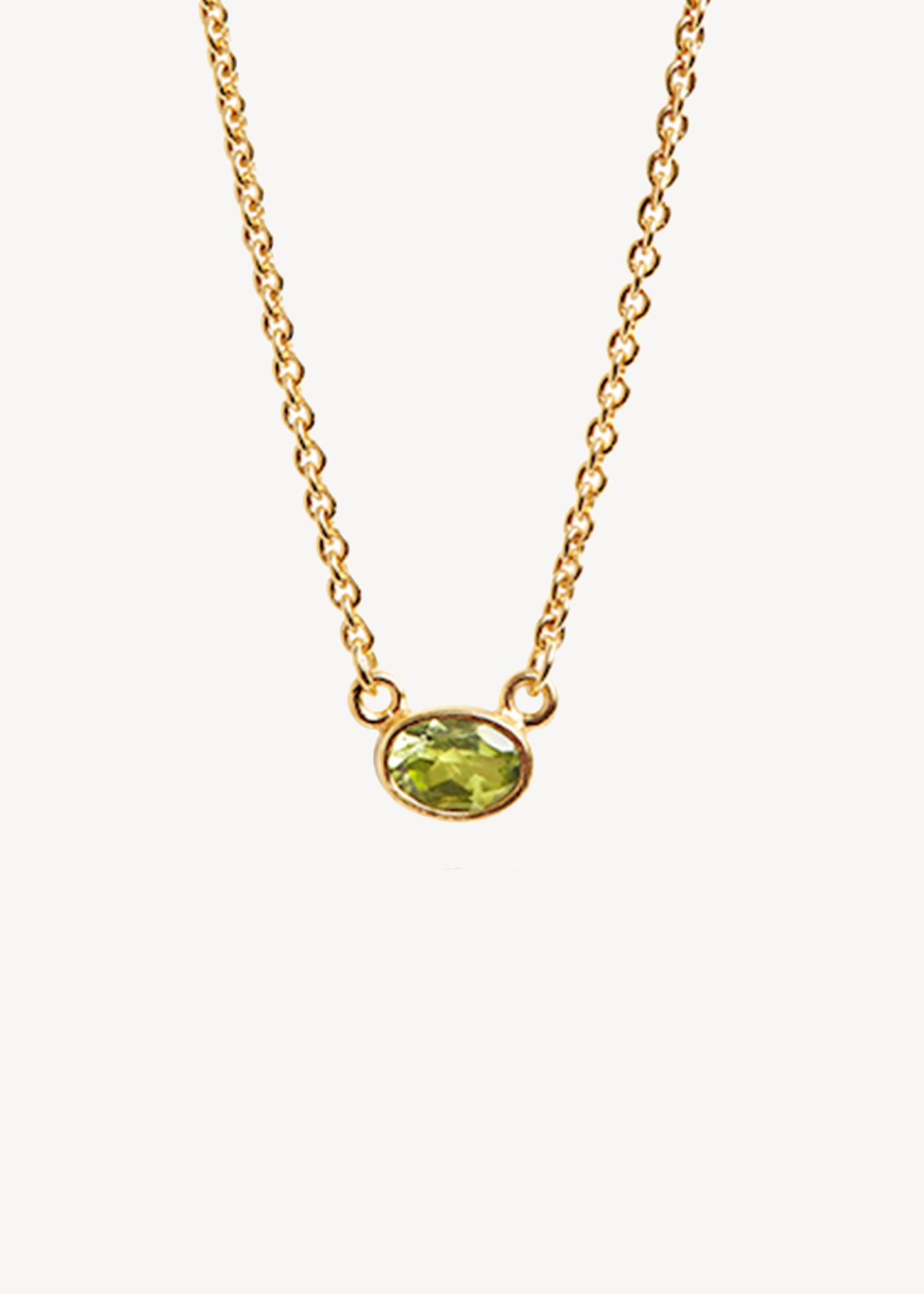 Cute and elegant gold necklace with a green peridot gemstone pendant in a bezel setting. Peridot is August's birthstone