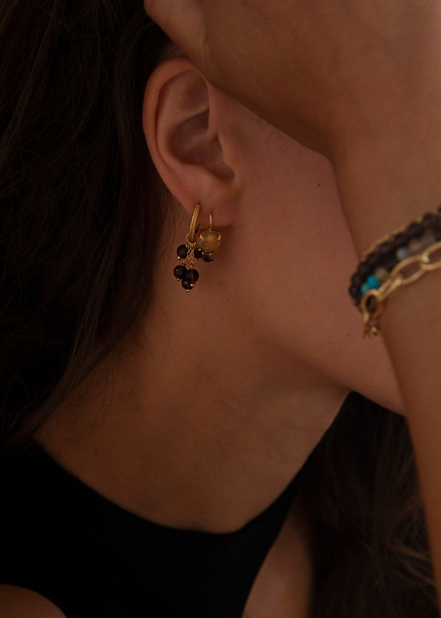 Woman with long dangling earrings with chains and hoop style with real brown quartz gemstones for her