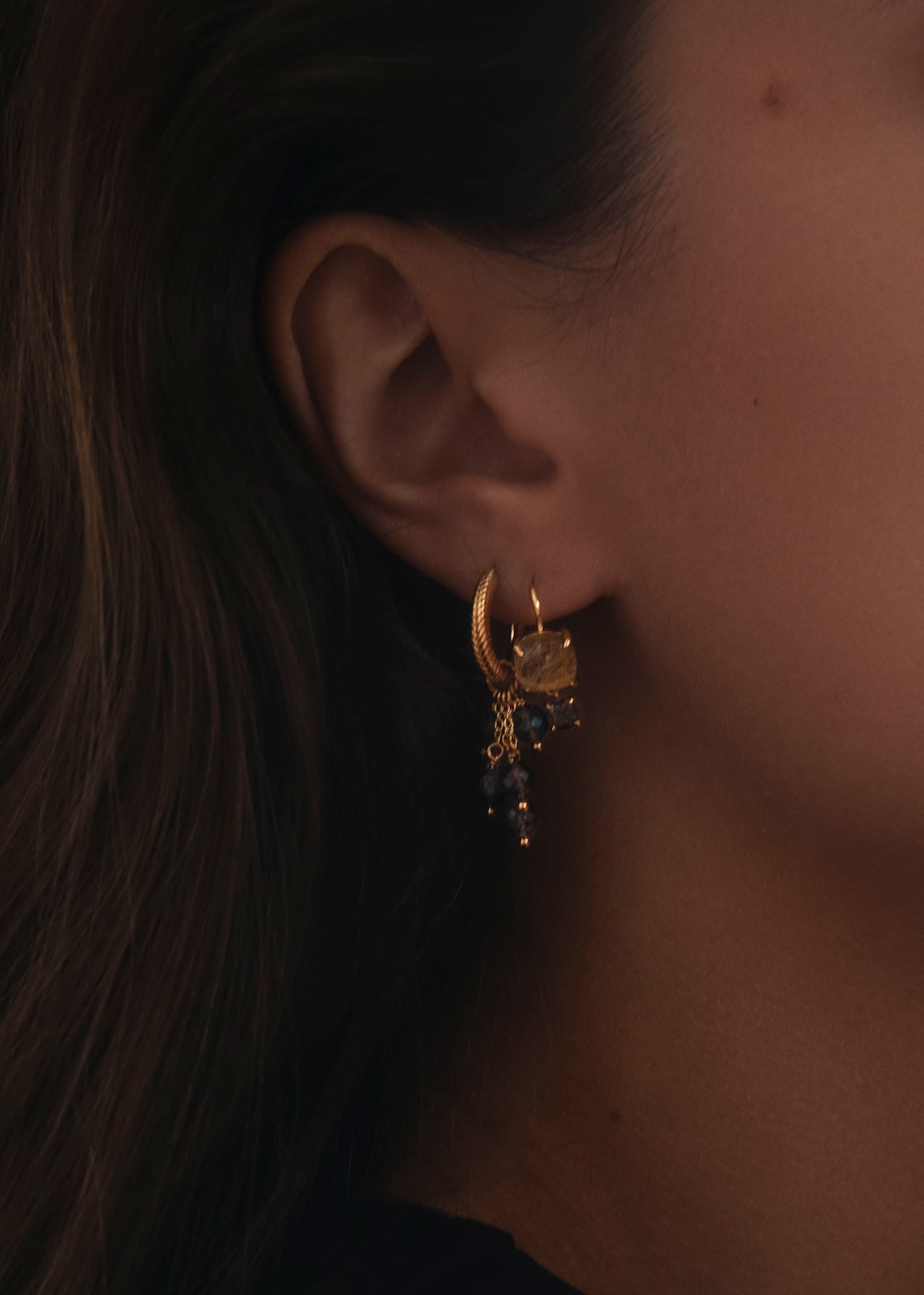 Woman with brown gold earrings