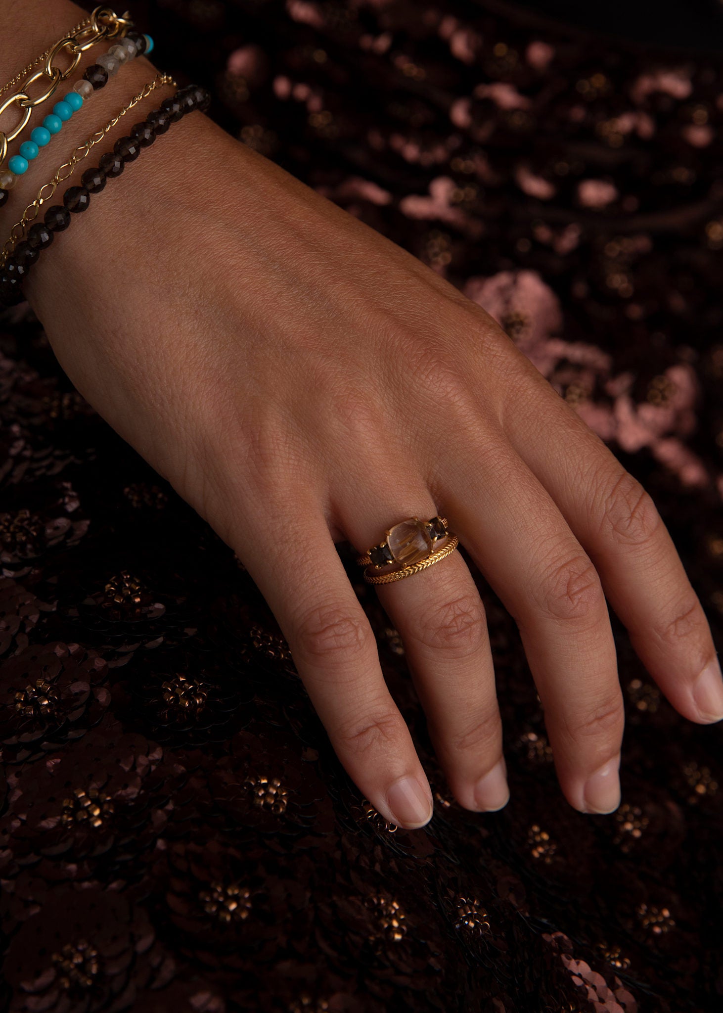 Woman with large three stone ring in Danish design for parties and everyday use with brown gemstones