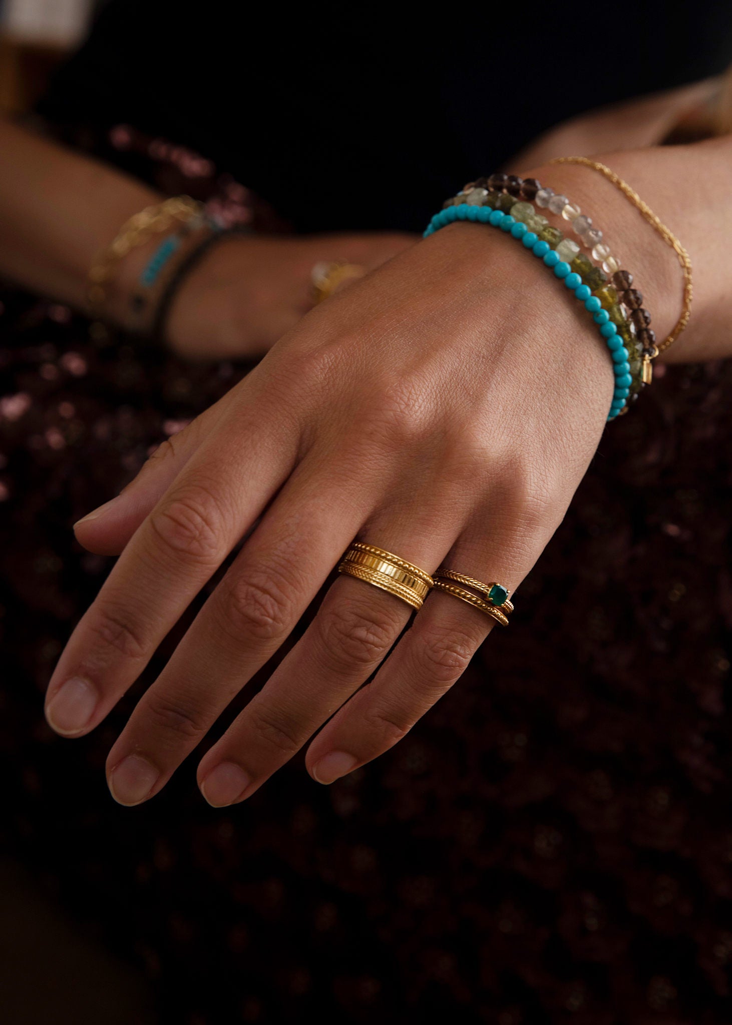 Woman with antique inspirered gold rings in Danish design with green agate gemstones in gold