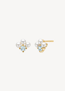 Bridal earrings in gold plated sterling silver with white freshwater pearls and facet cut blue topaz gemstones in a flower shape