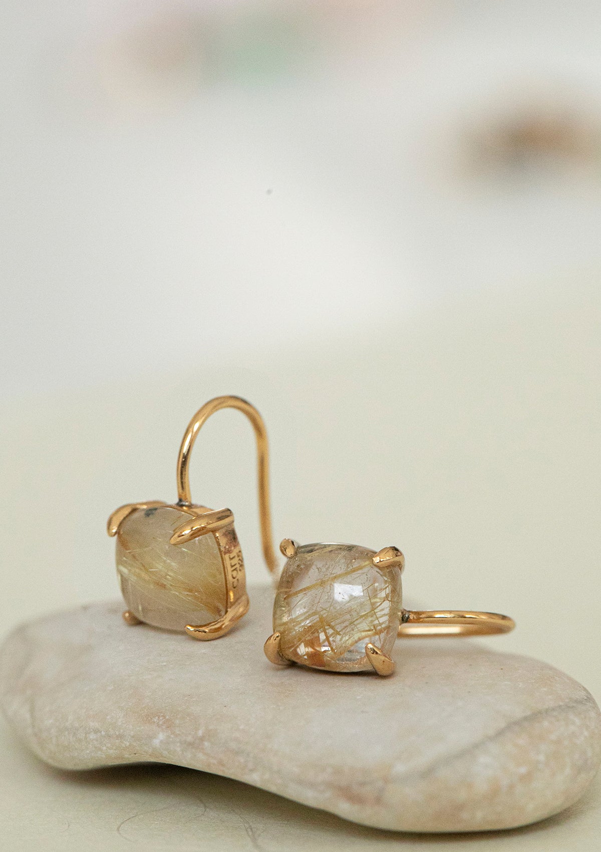 gold plated earrings with a large stone from carré. The stone is a golden rutile quartz gemstone