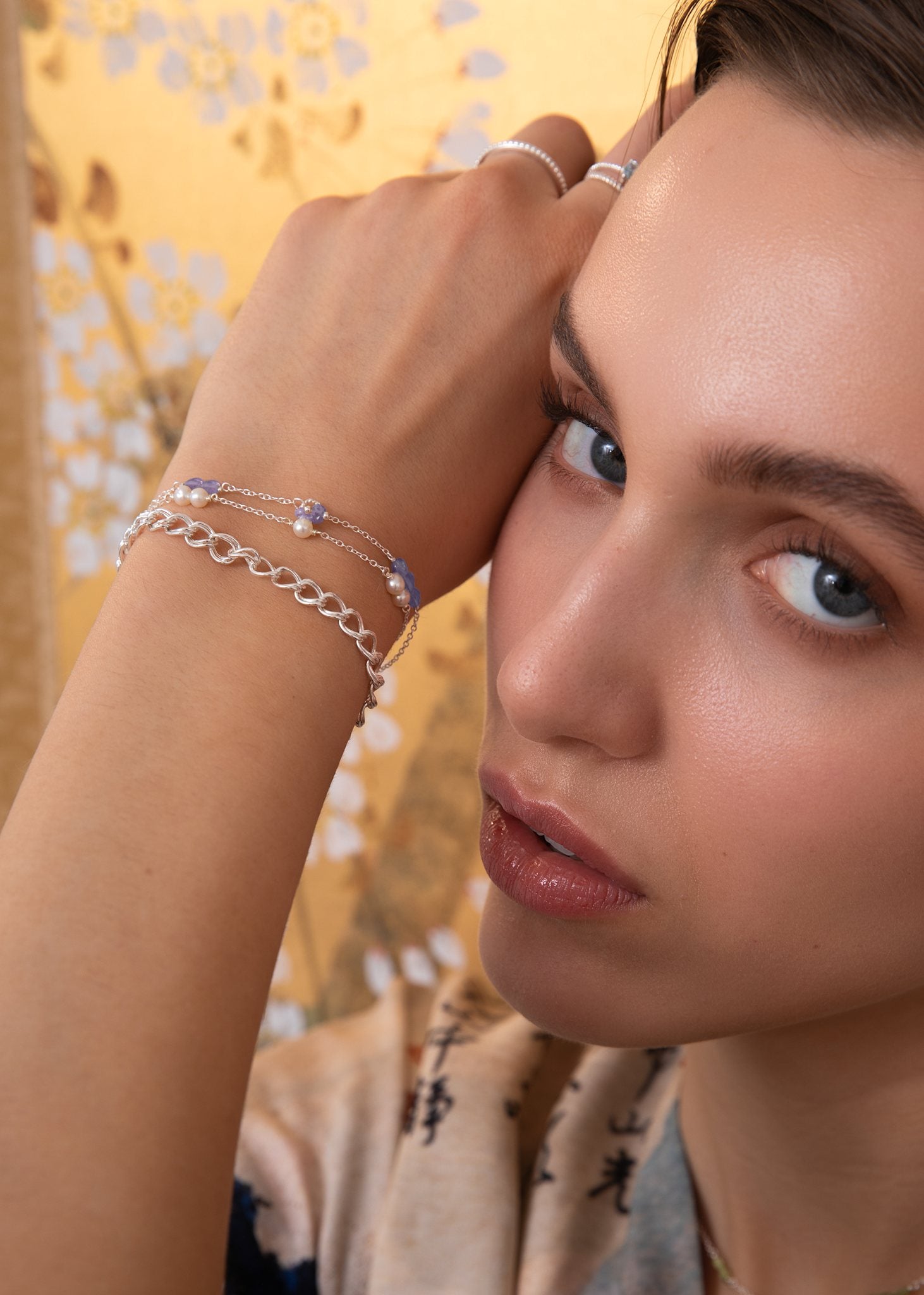 Woman with purple tanzanite bracelet with facet coin cut tanzanite gemstones for men and women in sterling silver