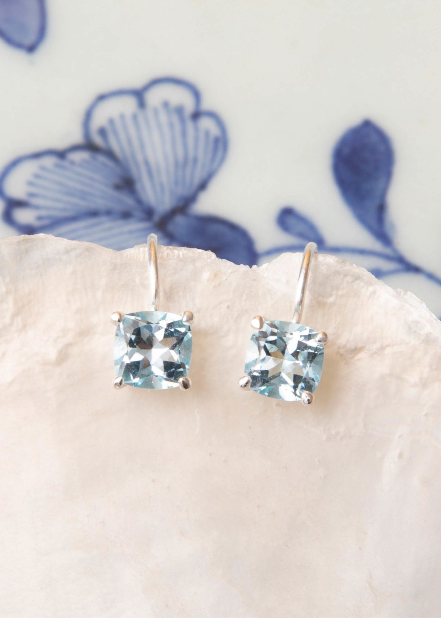 Sterling silver earrings from carré jewellery with facet cut blue topaz gemstones