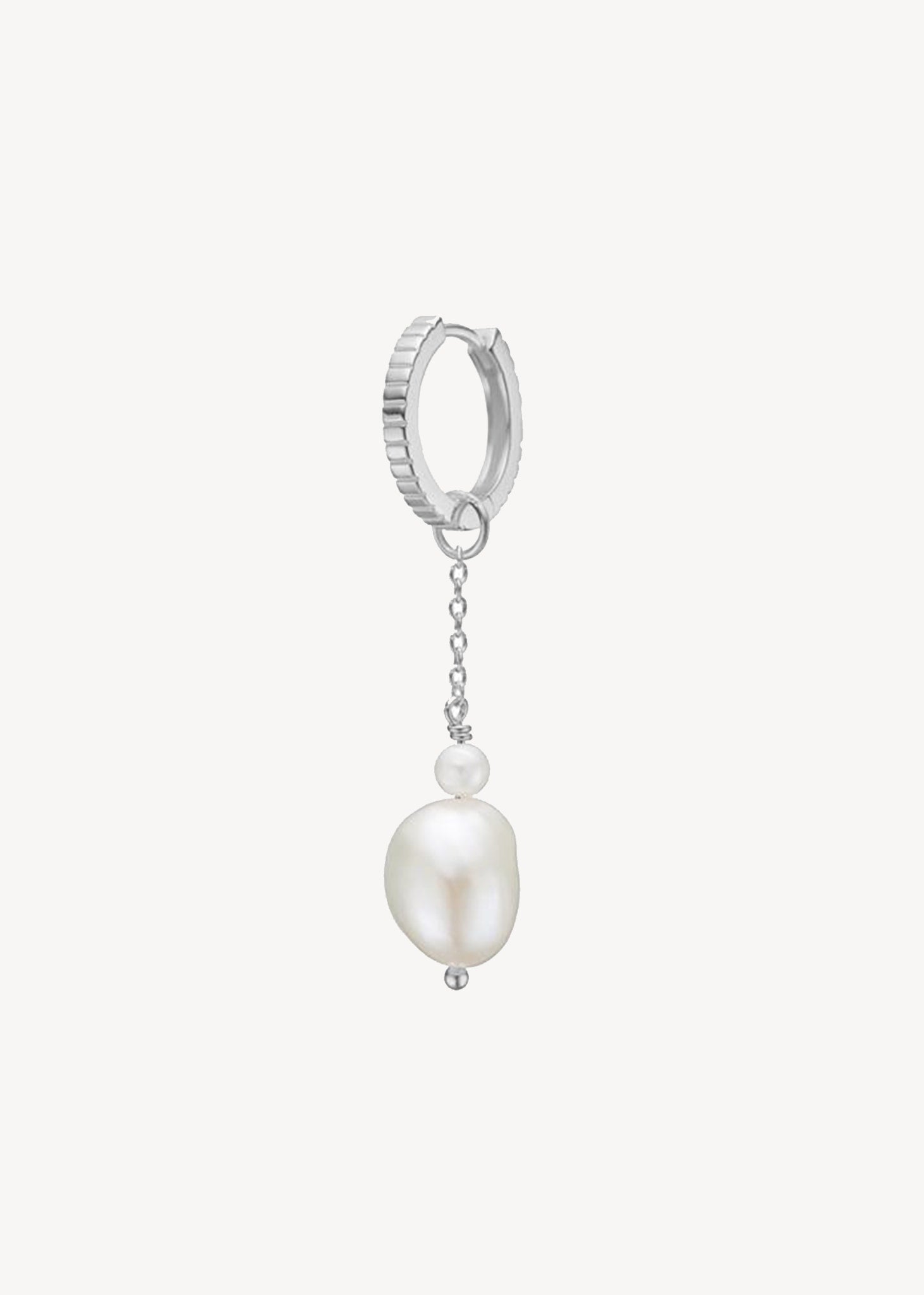 Sterling silver creole hoop with pinstripes with a silver reshwater pearl charm from Carré Jewellery