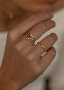 Woman wearing 10 karat gold small rings from carré jewellery in an elegant style set with pink tourmaline gemstones