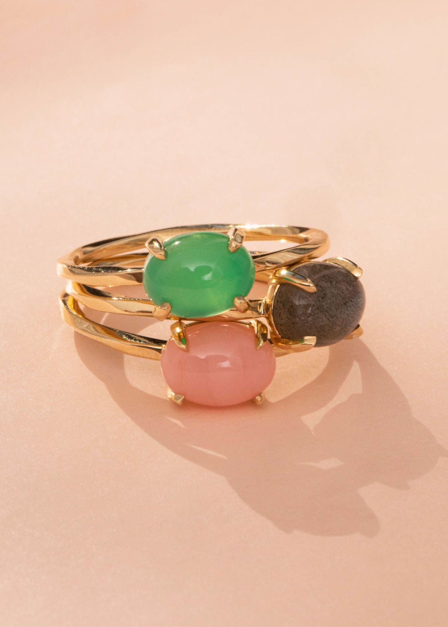 Three Tournure rings from Carré Jewellery in real 10-karat gold set with cabochon cut chrysoprase, labradorite and pink opal gemstones for wedding day jewellery