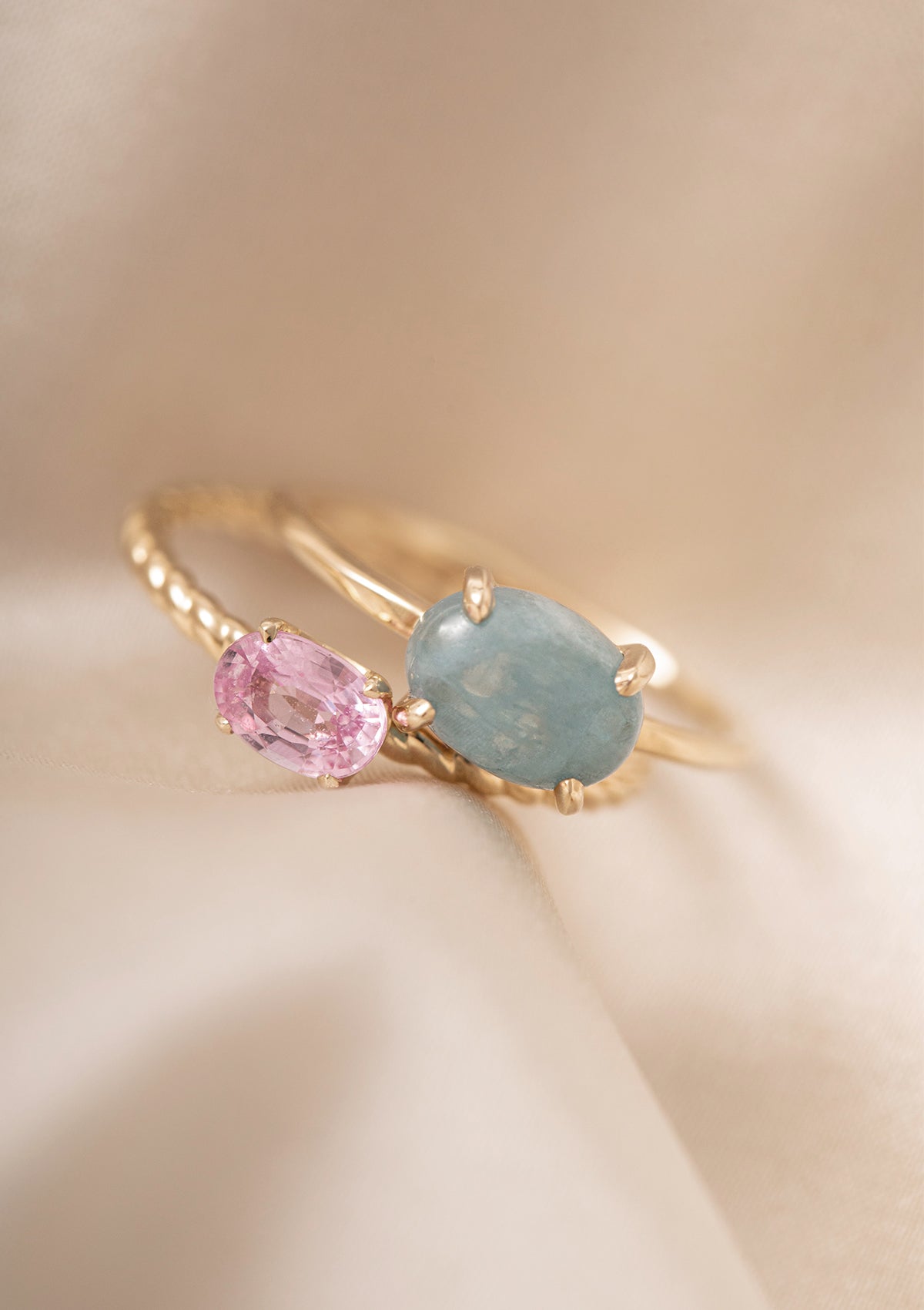 two solid gold rings from carré with an aquamarine gemstone and a pink sapphire