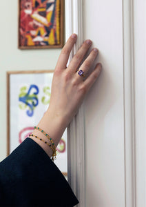 woman wearing a large gold plated ring from Carré with a large amethyst gemstone