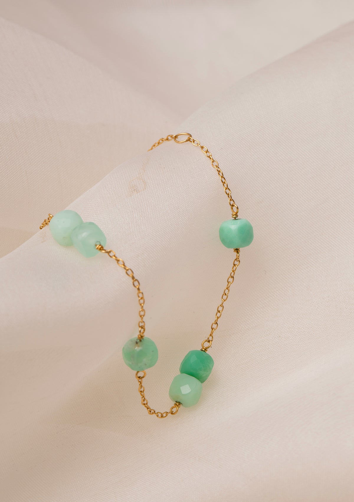 gold plated bracelet from carré with green stones. The green stones are chrysoprase gemstones