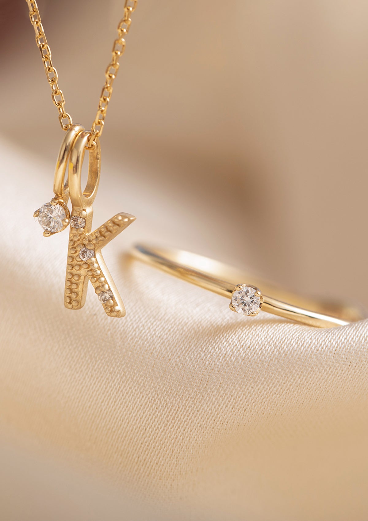 solid gold jewellery with diamonds from carré. A letter pendant with diamonds in the letter K, a diamond pendant for necklaces and a diamond engagement ring