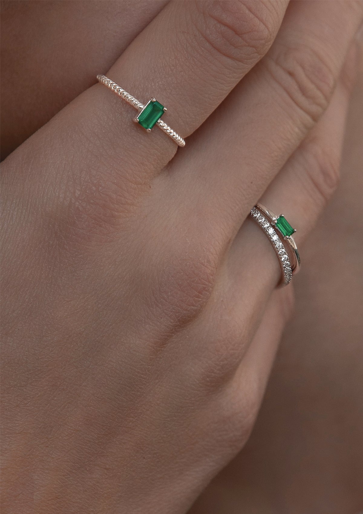 woman with silver rings with green stones from carré. The green stones are called green agate