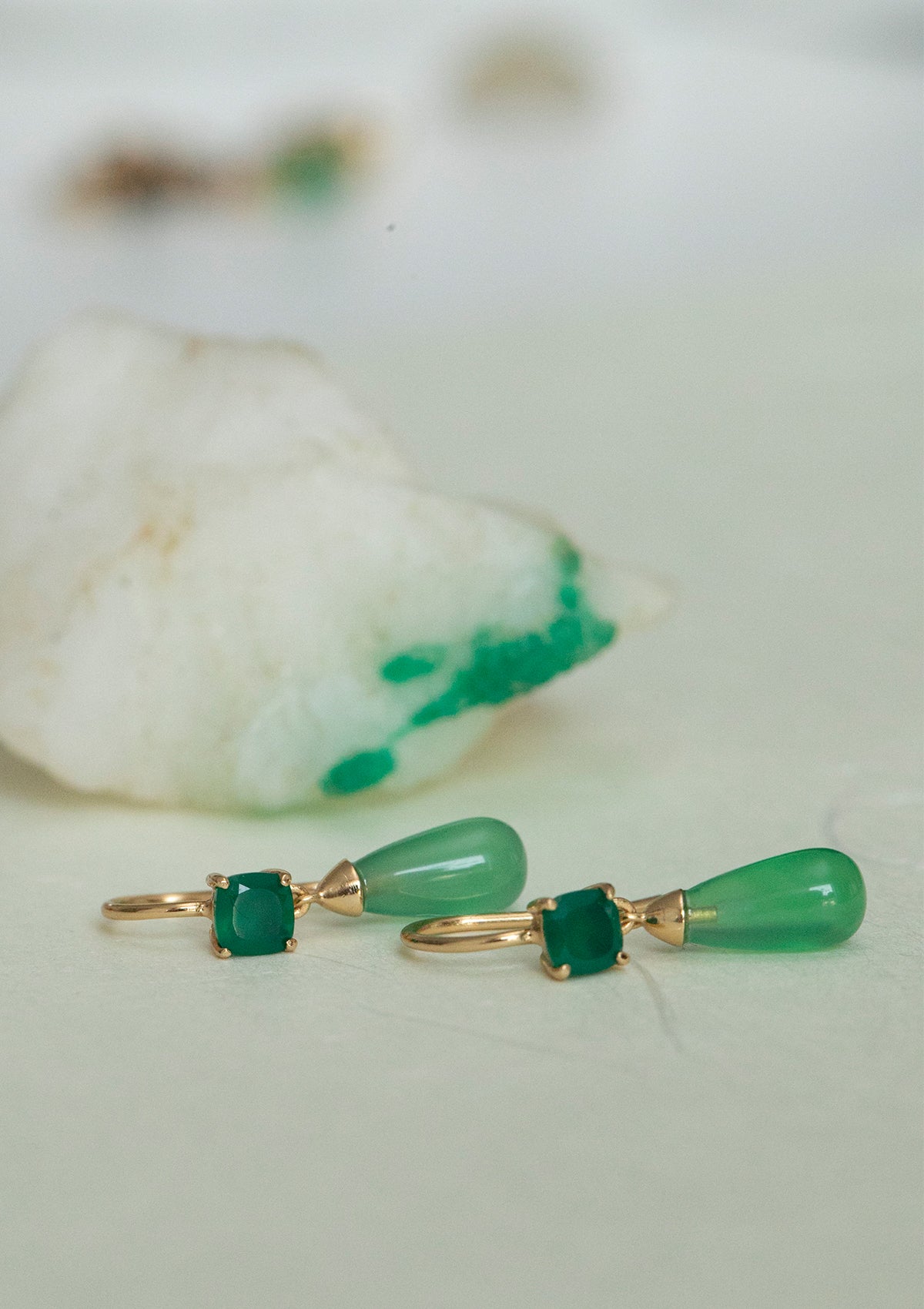 Long gold plated earrings with green stones from carré. The green stones are called green agate