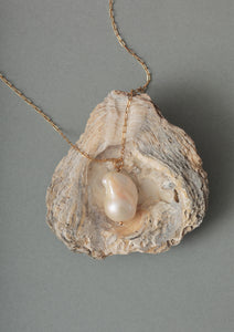 a large gold plated pearl necklace pendant on a garland chain from carré