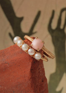 Two rings from carré jewellery in gold plated sterling silver set with round white freshwater pearls and cabochon-cut pink opal gemstones