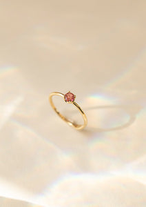 a solid gold engagement ring with a pink tourmaline stone from carré